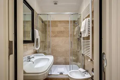 a bathroom with a sink and a shower at Hotel Domus Mea in Rome
