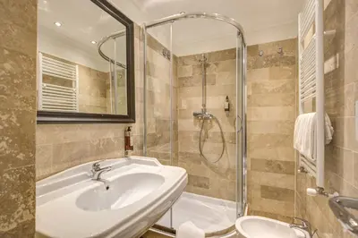 a bathroom with a sink and a shower at Hotel Domus Mea in Rome