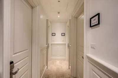 a hallway with white walls and white doors at Hotel Domus Mea in Rome
