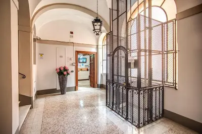 a hallway with a wrought iron gate with a vase of flowers at Magnifico Rome in Rome