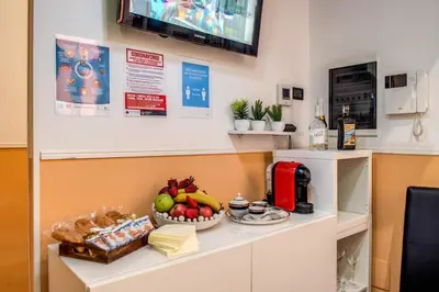 a kitchen with a counter with a bowl of fruit at Magnifico Rome in Rome