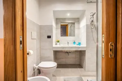a bathroom with a toilet and a sink at Magnifico Rome in Rome