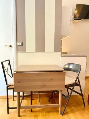 a wooden desk with two chairs next to it at Roome B&B in Rome