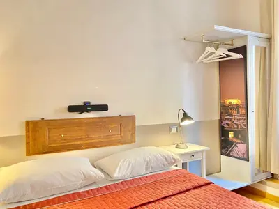 a bedroom with a bed with a speaker on the wall at Roome B&B in Rome