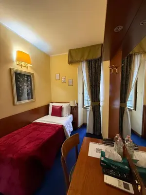 a hotel room with a bed and a desk at Hotel Fenicia in Rome