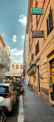 a street with cars parked on the side of a building at Hotel Fenicia in Rome
