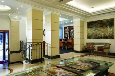 a lobby with a glass table in a building at Hotel dei Mellini in Rome