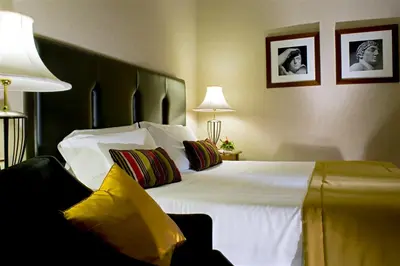 a bedroom with a large white bed with pillows at Hotel dei Mellini in Rome