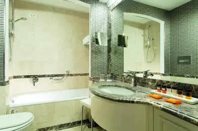 a bathroom with a sink and a tub and a toilet at Hotel dei Mellini in Rome
