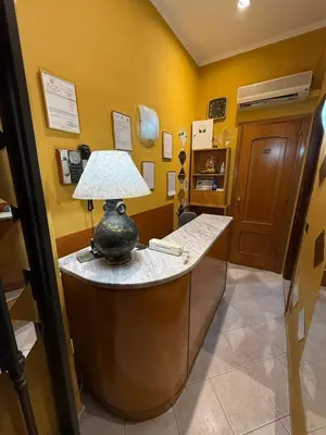 a room with a desk with a lamp on it at Viennese Due in Rome