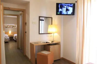 a hotel room with a television on a wall at Hotel Sisto V in Rome