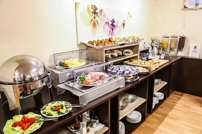 a buffet with many plates of food on display at Hotel Sisto V in Rome