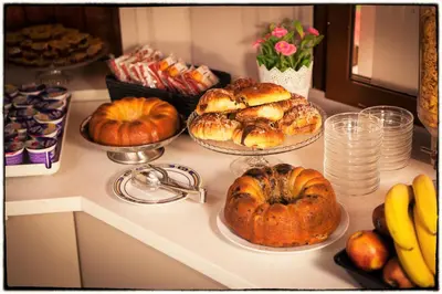 a counter with many different types of bread and pumpkins at Hotel d'Este in Rome
