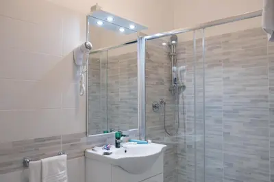 a bathroom with a shower and a toilet and a sink at Hotel d'Este in Rome