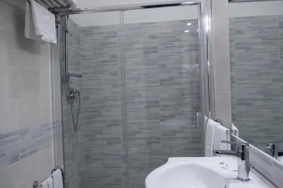 a bathroom with a shower and a toilet and a sink at Hotel d'Este in Rome