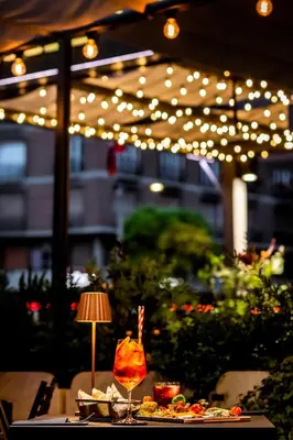 a table with food and a lamp and lights at Trilussa Palace Hotel Congress & Spa in Rome