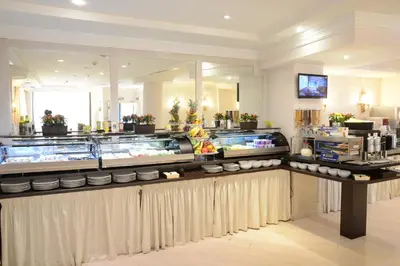 a restaurant with a counter with bowls and food at Trilussa Palace Hotel Congress & Spa in Rome