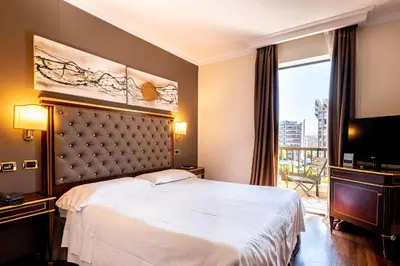 a hotel room with a bed and a television at Trilussa Palace Hotel Congress & Spa in Rome