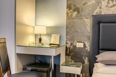 a bedroom with a desk with a bed and a lamp at Residenza Belli Inn in Rome