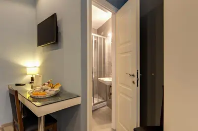 a corridor of a bathroom with a sink and a mirror at Residenza Belli Inn in Rome