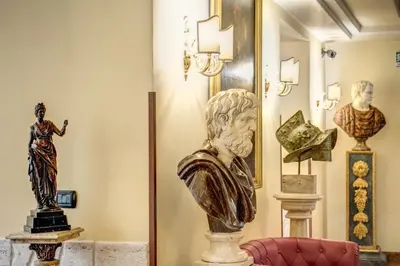 a bust of a woman and other statues in a room at Hotel Aurelius in Rome