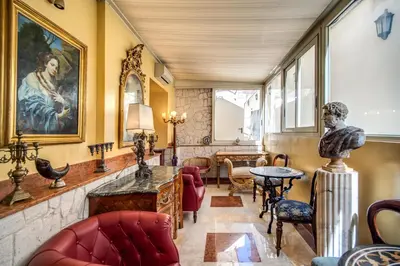 a living room with a table and chairs at Hotel Aurelius in Rome