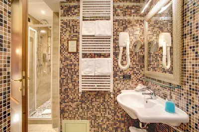 a bathroom with a sink and a mirror at Hotel Aurelius in Rome