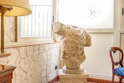 a statue in a room next to a window at Hotel Aurelius in Rome