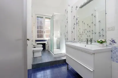 a white bathroom with a sink and a toilet at 4BNB - Chinotto Spacious Apartment in Rome