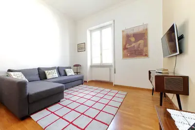 a living room with a couch and a television at 4BNB - Chinotto Spacious Apartment in Rome