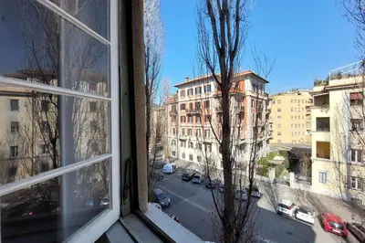 a window with a view of a street and buildings at 4BNB - Chinotto Spacious Apartment in Rome