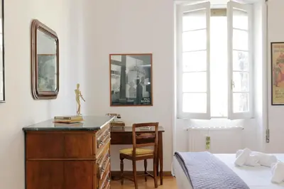 a bedroom with a dresser and a bed and a chair at 4BNB - Chinotto Spacious Apartment in Rome