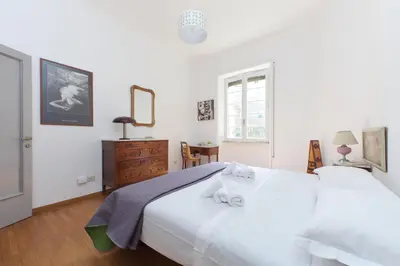 a bedroom with two white beds and a dresser at 4BNB - Chinotto Spacious Apartment in Rome