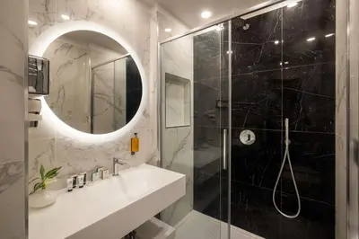 a bathroom with a shower and a sink and a mirror at Hotel Diana Roof Garden in Rome