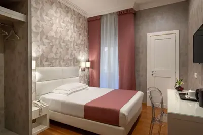 a bedroom with a large white bed in a room at Hotel Diana Roof Garden in Rome
