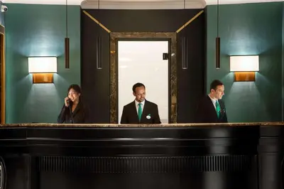 two men and a woman standing in front of a mirror at Hotel Diana Roof Garden in Rome