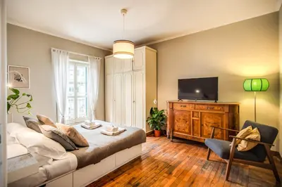 a living room with a couch and a tv at RR Apartments San Giovanni in Rome