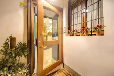 an open door with potted plants and a window at Hotel Gea Di Vulcano in Rome