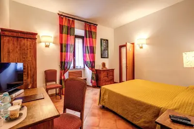 a hotel room with a bed and a television at Hotel Gea Di Vulcano in Rome