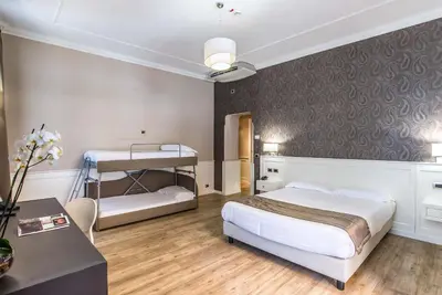 a hotel room with a bed and a desk and a bed sidx sidx sidx sidx at Hotel Museum in Rome