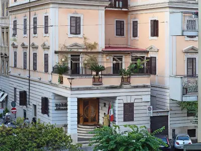 a building with potted plants on the front of it at Hotel Museum in Rome