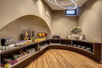 a breakfast room with a buffet of food at Al Manthia Hotel - Gruppo Trevi Hotels in Rome