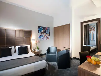 a hotel room with a bed and a desk at Hotel Trevi - Gruppo Trevi Hotels in Rome