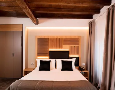 a bedroom with a large white bed with black pillows at Hotel Trevi - Gruppo Trevi Hotels in Rome