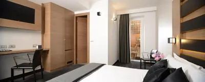 a bedroom with a bed and a desk and chairs at Hotel Trevi - Gruppo Trevi Hotels in Rome