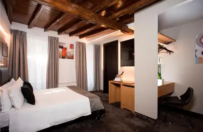 a hotel room with a bed and a desk and a desk at Hotel Trevi - Gruppo Trevi Hotels in Rome
