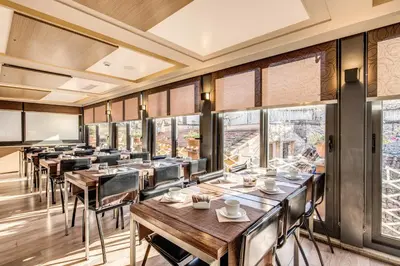 a restaurant with wooden tables and chairs and windows at Hotel Trevi - Gruppo Trevi Hotels in Rome