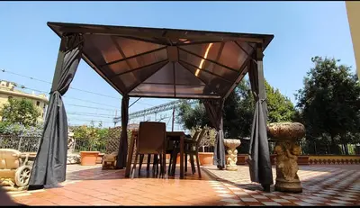 a gazebo with chairs and a table on a patio at Er Centurione in Rome