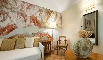 a living room with a couch and a painting on the wall at Le Clarisse Trastevere in Rome