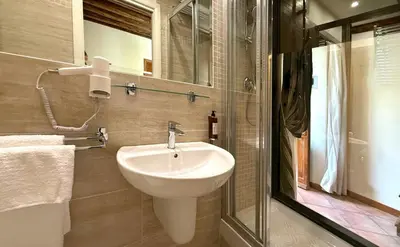 a bathroom with a white sink and a shower at Le Clarisse Trastevere in Rome